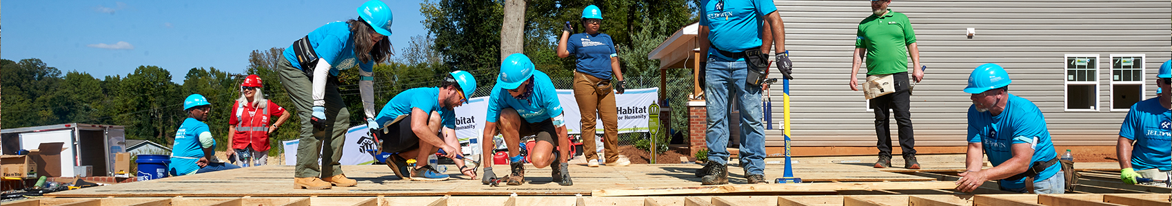 Habitat volunteers working together on a house construction project