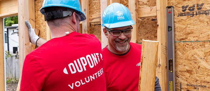 QL_Corporate Volunteers Corporate volunteer working on a Habitat home construction project