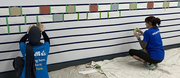 QL_Restore Volunteers painting a wall